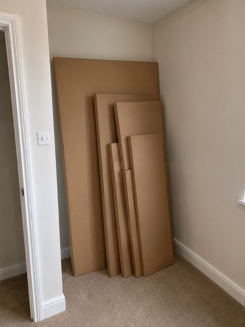 Before — flat-pack wardrobe panels still boxed