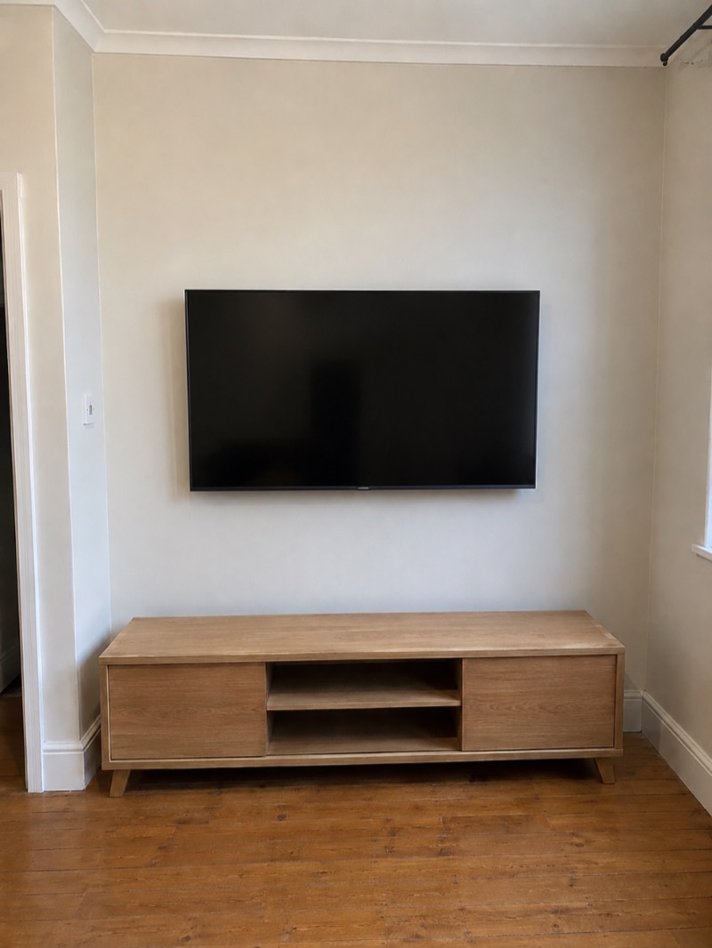 After — TV wall-mounted with cables hidden in a Leith living room