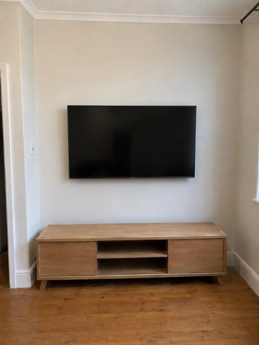 After — TV wall-mounted with cables hidden in a Leith living room