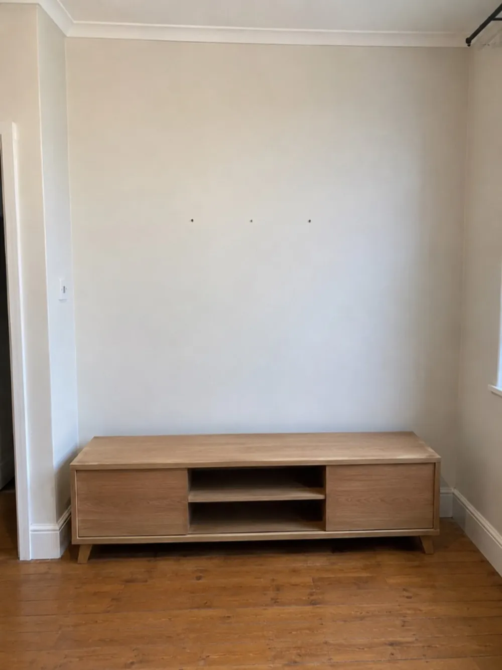 Before — bare wall and unit before TV mounting